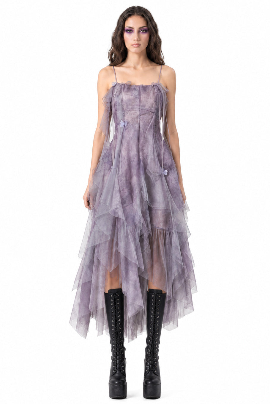 Woman wearing a purple dress with sheer panels on a white background