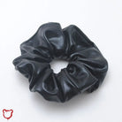 The Cursed Closet Black PU hair scrunchie at $11.99 USD